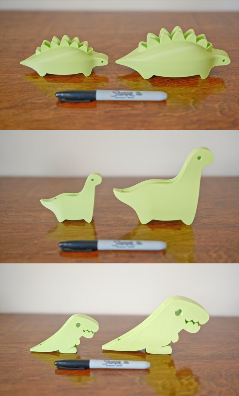 May include: Three green dinosaur-shaped doorstops of varying sizes. The largest doorstop is a stegosaurus with plates on its back. The middle doorstop is a brachiosaurus with a long neck. The smallest doorstop is a tyrannosaurus rex with a short neck and small arms.