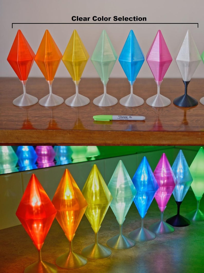 May include: A row of diamond-shaped decorative objects in a range of colours: red, orange, yellow, green, blue, pink, and white. Each sits on a slender stem and base. The text "Clear Color Selection" is above the objects.