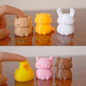Peut inclure: Un ensemble de six petites figurines d'animaux color&eacute;es. Les figurines sont en plastique et ont un style cartoon. Les animaux comprennent un chien brun, un chat orange, un lapin blanc, un canard jaune, un cochon rose et un ours brun.