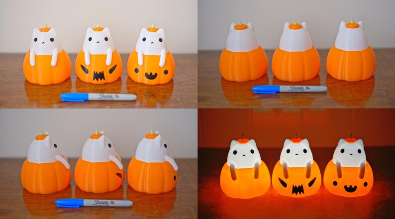 May include: A collection of orange and white cat-shaped Halloween decorations. The cats are sitting inside orange pumpkins with carved faces. A blue marker is placed in front of the decorations.