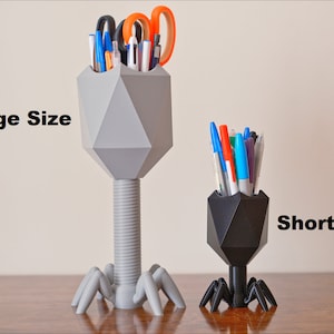 May include: Two 3D printed pen holders shaped like bacteriophages. The taller one is gray and the shorter one is black. The text "Tallest Large Size" is on the left and "Short Small Size" is on the right.