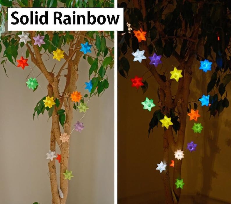May include: A string of star-shaped lights in various colors, including red, yellow, green, and blue, are strung on a tree. The text "Solid Rainbow" is displayed at the top. The lights are illuminated, creating a festive and colorful display.