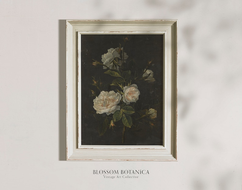 May include: A framed vintage botanical print featuring white roses on a dark background. The frame is white with a distressed finish. The print is titled "BLOSSOM BOTANICA Vintage Art Collective".