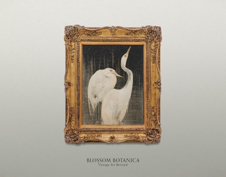 May include: A framed painting of two white birds with long necks and beaks, standing on a dark background. The frame is ornate and gold in color. The painting is titled "BLOSSOM BOTANICA Vintage Art Revived".