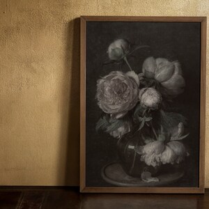 May include: A framed painting of a bouquet of white peonies in a dark brown vase. The flowers are arranged in a loose, natural style, and the background is a dark, almost black, color. The painting is framed in a simple, dark brown frame.