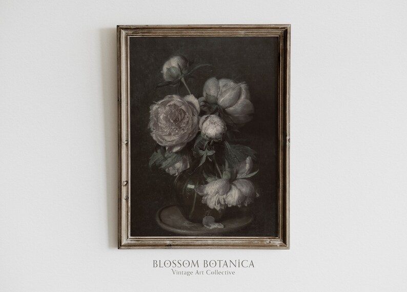 May include: A vintage framed painting of a bouquet of white and pink peonies in a dark vase on a table. The painting has a dark background and is framed in a simple, light wood frame.