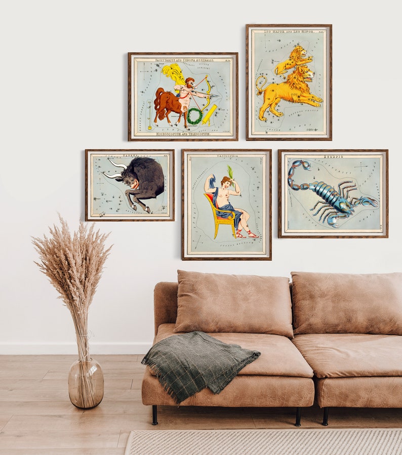 May include: Five framed vintage illustrations of constellations, each depicting a different zodiac sign. The signs are Sagittarius, Leo, Taurus, Gemini, and Scorpio. The illustrations are in a light blue and white color scheme with gold accents.