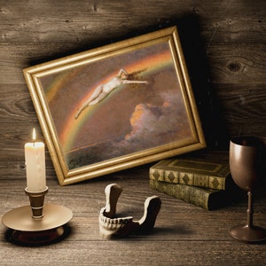May include: A framed painting of a woman flying through the air above a rainbow, a lit candle in a candlestick, a skull, and a goblet on a wooden surface.