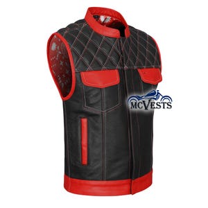 May include: Black leather vest with red detailing, including a quilted shoulder design and red pockets. The vest has a mandarin collar and a red interior lining with a white floral pattern. The brand logo "MC Vests" is visible on the right side.