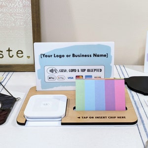 May include: A wooden stand with a white square card reader, a sign that says "[Your Logo or Business Name]" and the text "CASH, CARD & TOP ACCEPTED", and a sign that says "TAP OR INSERT CHIP HERE".