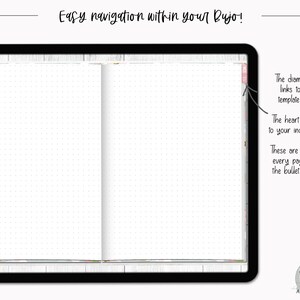 May include: A close-up of a white, dotted bullet journal with a black cover. The journal has two tabs on the right side, one diamond-shaped and one heart-shaped. The text "Easy navigation within your Bujo!" is at the top of the image.
