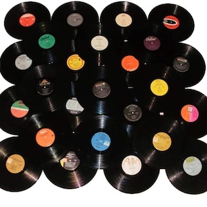 May include: A collection of vintage vinyl records in various colors, arranged in a circular pattern. The records are black with colorful labels.
