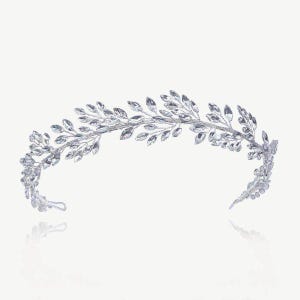 May include: A silver-toned bridal tiara with a leaf design. The tiara features a curved band adorned with clear, sparkling crystals arranged in a leaf-like pattern. The design is symmetrical, with the leaves extending from the center to the sides.