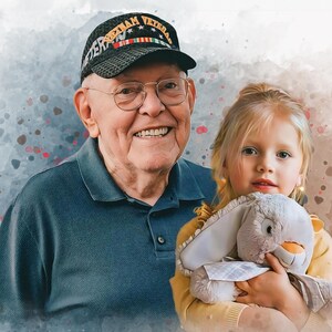May include: A smiling older man wearing a blue shirt and a black cap with the text "Vietnam Veteran" is holding a young girl. The girl is holding a grey stuffed bunny and wearing a yellow shirt.