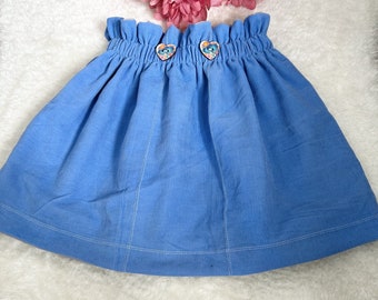 High-waisted blue corduroy skirt with decorative buttons