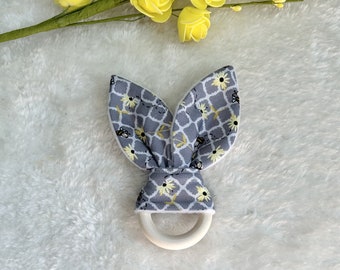 Teething ring - Rabbit ears rattle - Mini bees on a gray background