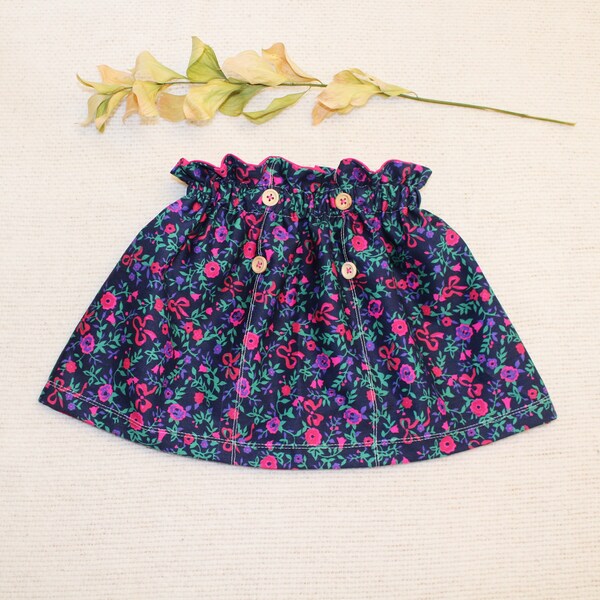 High-waisted skirt with floral patterns and decorative buttons