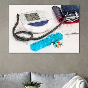 May include: A white digital blood pressure monitor with a black cuff, a blue pill organiser with a variety of pills, and a white background.