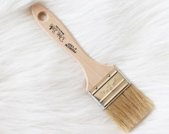 May include: A 2-inch wide paint brush with a wooden handle. The handle is labeled "Premium 2-inch Chirp" and "Dave's Brush Made in USA".