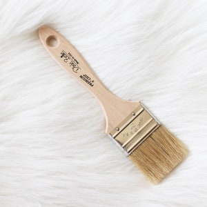 May include: A 2-inch wide paint brush with a wooden handle. The handle is labeled "Premium 2-inch Chirp" and "Dave's Brush Made in USA".