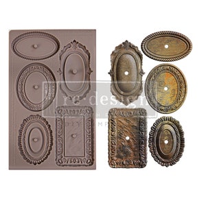 May include: A silicone mold with six different ornate oval frame designs. The mold is brown and has a textured surface. The frames are all different sizes and have intricate details. The mold is perfect for creating decorative accents for crafts and home decor.