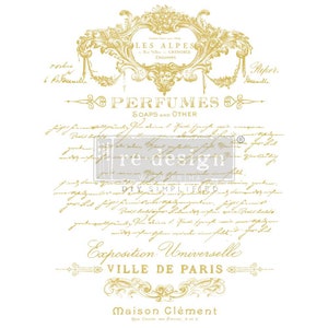 May include: Gold-toned graphic design with a vintage French-inspired design. The text reads "LES ALPES", "PERFUMES", "SOAPS AND OTHER", "Exposition Universelle", "VILLE DE PARIS", and "Maison Clément".