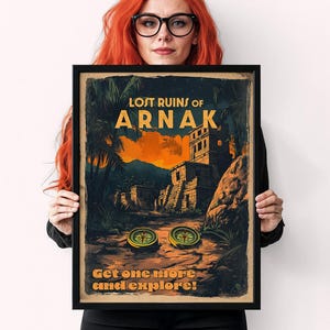 May include: A vintage-style poster advertising the board game "Lost Ruins of Arnak". The poster features a colorful illustration of a jungle scene with ancient ruins and two compasses. The text on the poster reads "Lost Ruins of Arnak" and "Get one more and explore!"