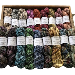 May include: A collection of 15 skeins of alpaca yarn in various colors and patterns. Each skein is labeled "The Alpaca Yarn Company Espiral 100% Alpaca 35 oz (100g) - 450 yds".