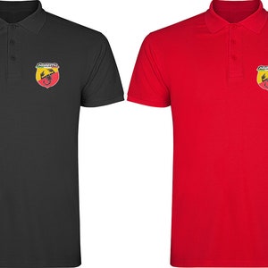 May include: Two polo shirts with the Abarth logo embroidered on the left chest. The shirt on the left is black and the shirt on the right is red.