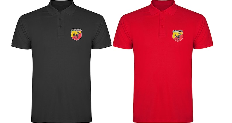 May include: Two polo shirts with the Abarth logo embroidered on the left chest. The shirt on the left is black and the shirt on the right is red.
