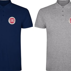 May include: Two polo shirts with the Fiat logo embroidered on the left chest. The shirt on the left is navy blue and the shirt on the right is gray.