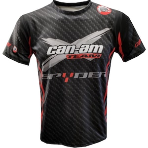 May include: Black short-sleeved t-shirt with a red, white, and gray graphic design. The graphic features the text "Can-Am Team Spyder" with a stylized logo.