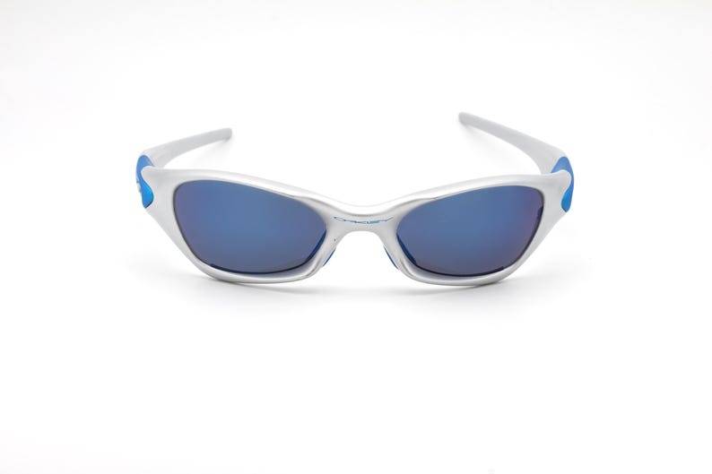 May include: Silver sunglasses with blue accents and blue mirrored lenses.