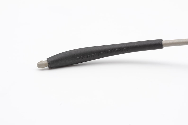 May include: Close-up of a black rubber temple tip with the words "Made in USA" printed on it.