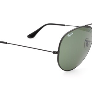 May include: Black aviator sunglasses with green lenses and Ray-Ban branding on the frame.