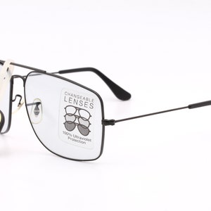 May include: Black rectangular frame glasses with clear lenses. The glasses have a label that says "Changeable Lenses" and "100% Ultraviolet Protection". A small tag attached to the glasses says "Original Bausch & Lomb".