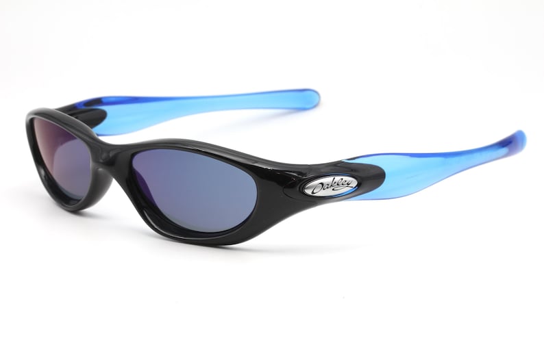May include: Black Oakley sunglasses with blue arms and blue tinted lenses.