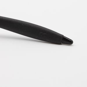 May include: Close-up of a black rubber temple tip with the letters "CG" embossed on the side.