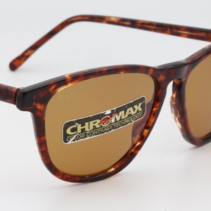May include: Brown tortoiseshell sunglasses with brown lenses. The glasses have a rectangular frame and the text "CHROMX COLOR CONTRAST TECHNOLOGY" is visible on the lens.