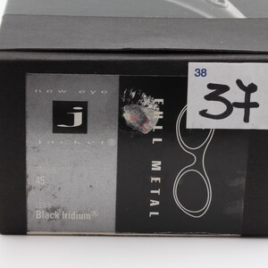 May include: Black box with a label that reads "FULL METAL" and "Black Iridium". The box has a sticker with the number "37" on it. The brand logo "j" is visible on the box.
