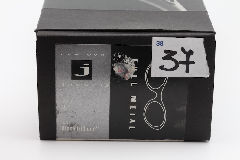 May include: Black box with a label that reads "FULL METAL" and "Black Iridium". The box has a sticker with the number "37" on it. The brand logo "j" is visible on the box.