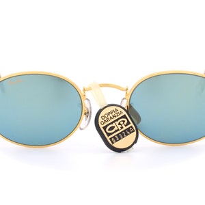Super trendy Ray Ban B&L W1862 XPAS vintage oval sunglasses with gold frames and blue mirrored lenses, made in U.S.A. 90's