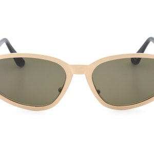 May include: Gold-toned oval sunglasses with dark gray lenses.