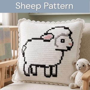 May include: A square white crochet pillow featuring a pixelated sheep design in black, gray, and pink yarn. The pillow has a scalloped edge border and is accompanied by a small, matching crocheted sheep plush toy. The text Sheep Pattern is visible.