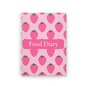 May include: A pink spiral-bound food diary with a repeating pattern of pink strawberries with green stalks. The words "Food Diary" are printed in white on a pink label across the cover.
