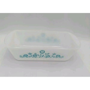 May include: White rectangular baking dish with a blue floral design. The dish is made of glass and has a smooth, glossy finish.