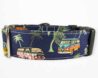 May include: A blue dog collar with a pattern of palm trees and vintage vans. The collar has a silver D-ring and a black plastic buckle.