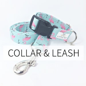 May include: A turquoise blue dog collar and leash set with a pink flamingo print. The collar has a black plastic buckle and the leash has a silver clip. The collar has the text "Little Pet" printed on it.