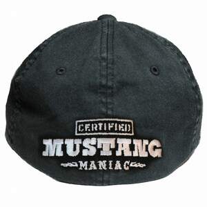 May include: Black baseball cap with white embroidered text that reads "CERTIFIED MUSTANG MANIAC".