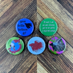 May include: Five round button pins with different designs featuring betta fish and text. The text on the buttons reads "you betta believe it!" and "To most, I am no one special but to my betta, I rule the world."